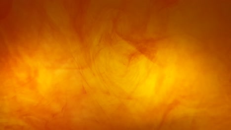 Ink-swirls-creating-a-fire-burning-effect-with-orange-and-red-dye-moving-in-the-water,-beautiful-background-color-footage