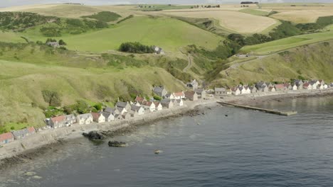 Aerial-view-of-the-Crovie-village-on-the-Aberdeenshire-coastline-on-an-overcast-summer-evening