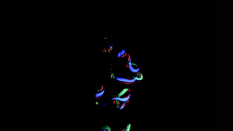Fantastic-dancer-with-glow-in-the-dark-bodypaint-circling-her-arms-around-her