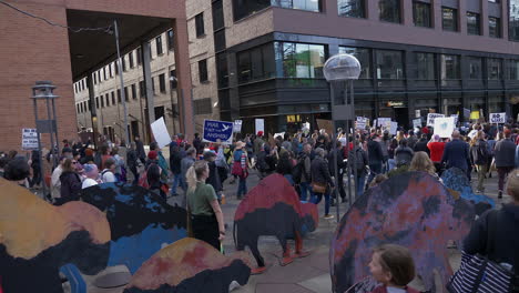 Anti-war-protesters-marching-through-the-streets-in-downtown-Denver,-Colorado