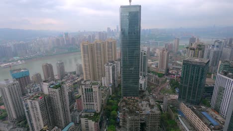 Daytime-time-lapse-of-green-skyscraper-building-under-construction-near-the-Yangtze-River-as-clouds-advance-and-the-sun-shines