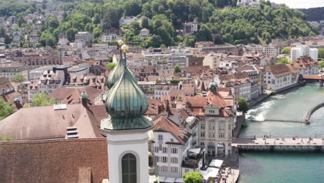 Aerial-of-beautiful-old-church-towers-in-the-city-of-Luzern,-Switzerland