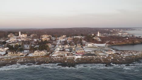 Two-Lighthouse-in-a-coastal-neighborhood-during-pink-winter-sunrise-AERIAL-SLIDE