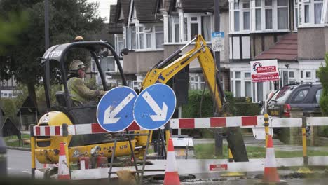 Mini-Excavator-Digging-Up-Road-To-Replace-Gas-Pipes-In-London
