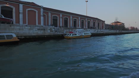 Vaporetto-ride-along-the-channel-Scomenzera,-Santa-Marta,-Venice,-Italy
