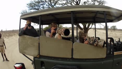 Photo-Safari-guests-striking-the-pose-in-a-tour-vehicle-in-the-desert
