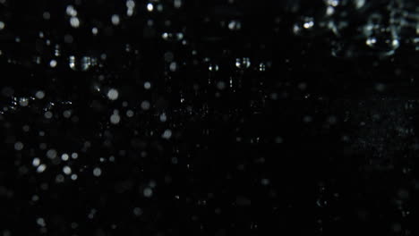 Bubbles-pouring-left-to-right-on-black-backdrop,-Overlay-Water-Effect