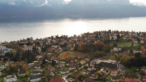 Tilt-up-from-small-town-to-beautiful-mountain-scape-at-Lake-Geneva