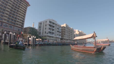 Boats-floating-on-Dubai-Creek,-Al-Fahidi-district-abra-harbor