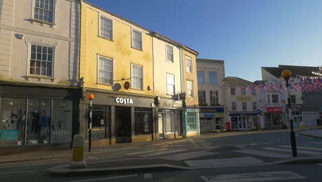 Pan-across-empty-British-town-centre-during-COVID-19-pandemic,-wide