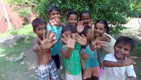 Little-poor-orphan-children-waving-goodbye-to-the-camera,-poverty-and-innocence,-slow-motion-forward-moving-shot