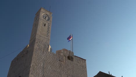 Castle-Komiza-at-dusk-with-the-Croatian-and-European-Union-flag-blowing