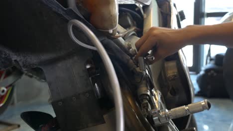 Close-up-Footage-of-Mechanic-Working-On-Installing-Brake-Cable-For-Motorcycle