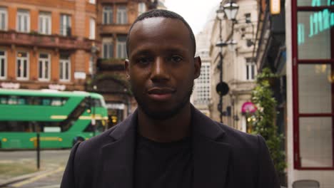 Black-male-looking-at-camera-on-a-busy-London-street