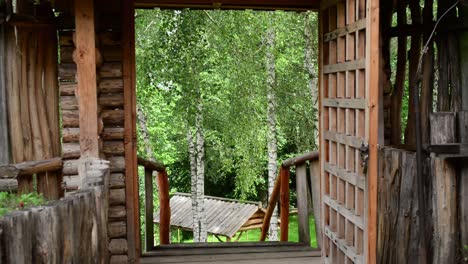 wood-cabin-door-open-reveal-a-natural-mountain-green-tree-landscape-calm-peaceful-and-unpolluted-outdoor-park
