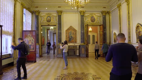 Tourists-walking-and-taking-pictures-in-hermitage-museum,-winter-palace-in-St-petersburg,-russia