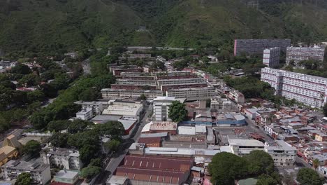Daytime-aerial-over-the-concrete-accommodation-of-Sarria,-located-in-the-west-of-Caracas,-Venezuela,-in-the-lush,-green-foothills-of-El-Ávila