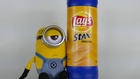 Minion-cartoon-character-with-Lays-chips,-minions,-yellow,-commercial-illustration,-cute,-funny,-eye,-look,-eyeglass,-emoji,-happy-head,-animation,-film,-famous-toy,-facial,-closeup-face,-comic-doll
