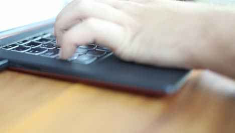 Hands-type-on-a-modern-computer-keyboard---isolated-close-up