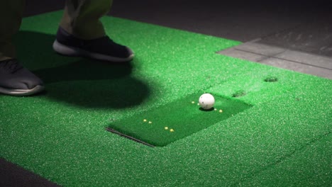 Indoor-golf-simulator-swing-with-an-iron,-club-hitting-ball