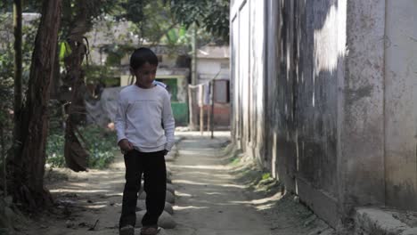 Young-Boy-Walking-Along-Stepping-Stones-In-Village-In-Sylhet,-Bangladesh