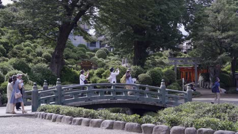 Group-of-Japanese-tourists-visiting-a-temple-during-Corona-Crisis,-wearing-facemasks
