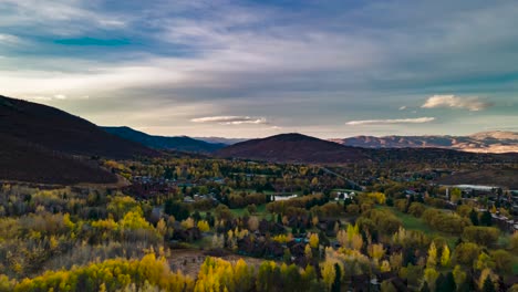 Aerial-hyperlapse-over-a-mountain-community-during-sunset-in-autumn