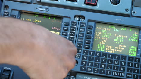 Pilot-Programming-The-Flight-Management-System-In-The-Airplane-Cockpit-At-The-Eindhoven-Airport,-Eindhoven,-Netherlands---close-up