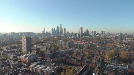 dolly-back-drone-shot-from-residential-London-looking-towards-the-financial-center-of-the-capital