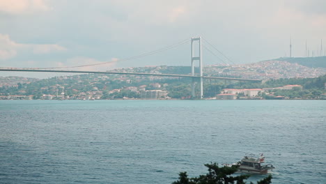 Bosphorus-with-Marmara-Sea-and-Iconic-Bridge-of-Istanbul-City-between-Asia-and-Europe-Continents-while-Boats-are-Passing-by-on-Blue-Water