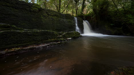 Panorama-motion-time-lapse-of-forest-waterfall-in-rural-landscape-during-autumn-in-Ireland