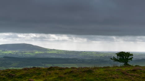 Time-lapse-of-rural-landscape-with-grass-fields-and-hills-during-a-cloudy-day-in-Ireland