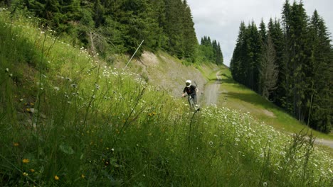 Mountain-biker-rides-fast-through-tall-grass