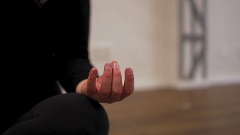Closeup-shot-of-female-yoga-instructor's-hand-in-her-fitness-studio