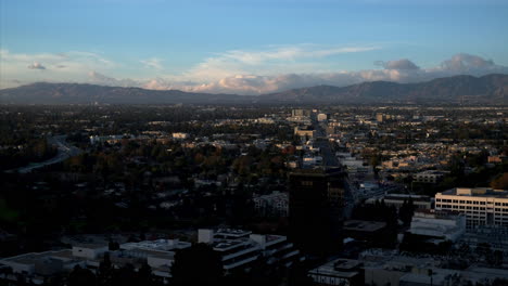 Time-Lapse-of-Clouds-Rolling-Over-Mountains-and-City,-Afternoon-Becomes-Evening-in-Burbank,-Blue-Sky