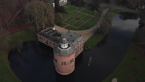 Aerial-ascend-and-backwards-movement-showing-Rosendael-castle-with-its-landscape-design-garden-and-moat-structure