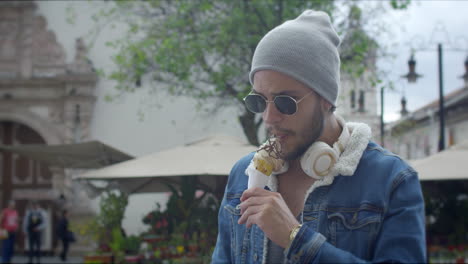 Handsome-guy-eating-ice-cream-on-the-street