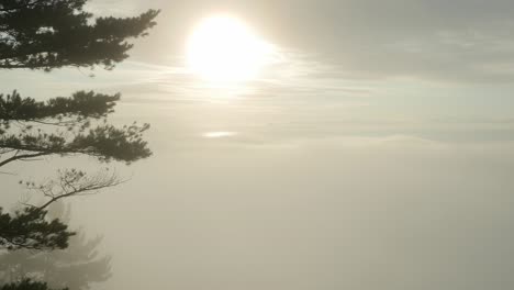 Sunrise-over-lake-superior-at-bare-bluff-with-morning-fog-rolling-in