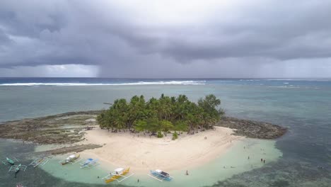 Aerial-forward-tracking-pedestal-up-shot-of-Guyam-Island,-Siargao,-the-Philippines