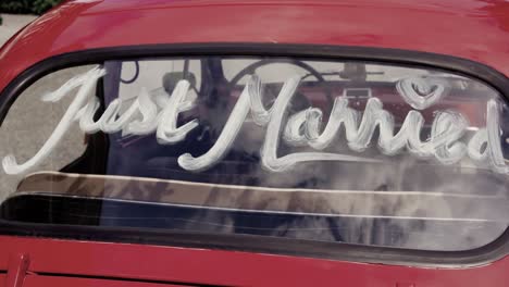 "just-married"-written-on-a-rear-window-of-an-old-car