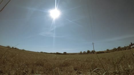 TIME-LAPSE---Sun-moving-across-the-sky-over-a-field-with-a-couple-objects-flying-in-the-sky-causing-cloud-trails