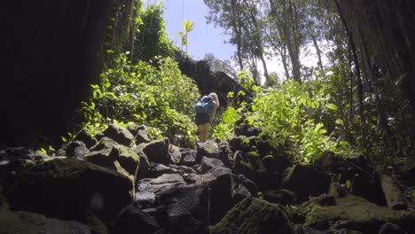 Woman-walking-out-of-a-cave-in-Hawaii