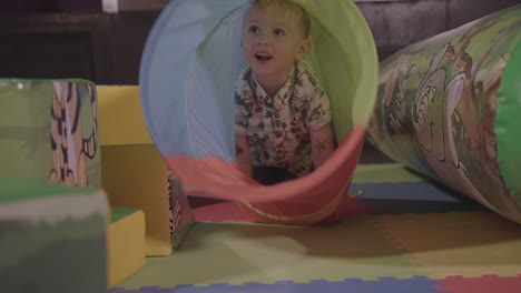 Young-Happy-Child-Having-an-Amazing-Time-Crawling-Through-a-Soft-Play-Tunnel---Ungraded