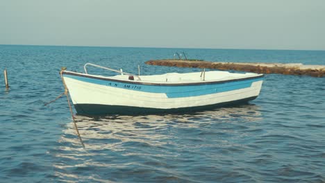 Small-fiber-glass-boat-anchored-at-beautiful-holiday-wanderlust-seaside-resort