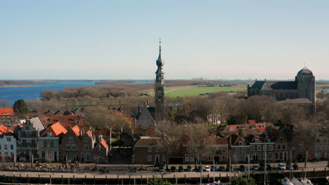 Aerial:-The-historical-town-of-Veere-with-an-old-harbour-and-churches,-on-a-spring-day
