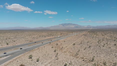 Falling-aerial-of-the-highway-leading-from-Barstow,-California-to-Las-Vegas,-Nevada