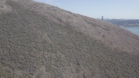 Aerial-Drone-Shot-of-Hill-Revealing-Golden-Gate-Bridge-San-Francisco