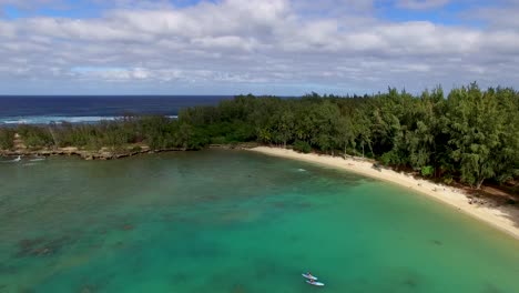 Aerial-shot-of-turquoise-Hawaiian-waters-of-Kawela-Bay-Beech-Park-near-the-Turtle-Bay-Resort