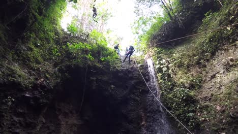 Ziplining-down-a-waterfall-in-Bali,-Indonesia