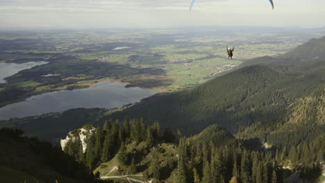 Person-paragliding-with-the-instructor-in-the-German-Alps